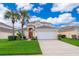 Two-story house with a brown door and palm trees at 8612 La Isla Dr, Kissimmee, FL 34747