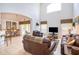 Living room with high ceilings, leather furniture and view of kitchen at 8612 La Isla Dr, Kissimmee, FL 34747
