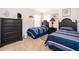 Bedroom featuring two twin beds, dresser, and cheerful decor at 8612 La Isla Dr, Kissimmee, FL 34747