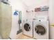 Laundry room with washer, dryer, and shelving at 8612 La Isla Dr, Kissimmee, FL 34747