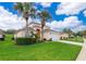Two-story house with a white garage door and palm trees at 8612 La Isla Dr, Kissimmee, FL 34747