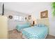 Bedroom with two twin beds, dresser, and plenty of natural light at 8612 La Isla Dr, Kissimmee, FL 34747