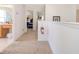 Upstairs hallway with carpet, leading to bedrooms and a bathroom at 8612 La Isla Dr, Kissimmee, FL 34747