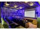 State-of-the-art home theater with luxurious seating and stunning geometric wall accents at 1125 Grand Traverse Pkwy, Reunion, FL 34747