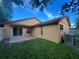 View of the home's backyard, showing a patio and fenced yard at 3180 Owassa Ct, Kissimmee, FL 34746