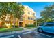 Attractive yellow building exterior with balconies and landscaping at 3593 Conroy Rd # 437, Orlando, FL 32839