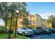 Condo building exterior with parking and landscaping at 3593 Conroy Rd # 437, Orlando, FL 32839