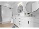Modern bathroom with double vanity and large mirrors at 494 Muirfield Loop, Reunion, FL 34747