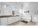 Luxurious bathroom with double vanity, soaking tub, and separate shower at 494 Muirfield Loop, Reunion, FL 34747