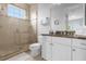 Bathroom with shower, toilet and granite countertop at 494 Muirfield Loop, Reunion, FL 34747