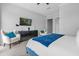 Bedroom with two armchairs and large dresser at 494 Muirfield Loop, Reunion, FL 34747