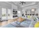 Living room featuring a fireplace, built-in entertainment center and pool access at 494 Muirfield Loop, Reunion, FL 34747