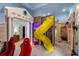 Playful ' room with a slide, cityscape theme, and racing simulators at 494 Muirfield Loop, Reunion, FL 34747