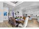 Large dining room with a spacious table and modern kitchen at 494 Muirfield Loop, Reunion, FL 34747