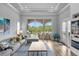 Bright living room featuring hardwood floors and sliding glass doors leading to the backyard at 494 Muirfield Loop, Reunion, FL 34747