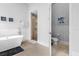 Elegant bathroom with freestanding tub and walk-in shower at 494 Muirfield Loop, Reunion, FL 34747