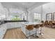 Open concept kitchen with large island, stainless steel appliances, and view of pool at 494 Muirfield Loop, Reunion, FL 34747
