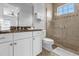Bathroom with shower, toilet and granite countertop at 494 Muirfield Loop, Reunion, FL 34747