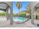 Resort-style pool with covered patio and safety fence at 494 Muirfield Loop, Reunion, FL 34747