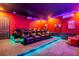 Sleek home theater with reclining seats and vibrant LED lighting at 494 Muirfield Loop, Reunion, FL 34747