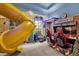 Fun game room with arcade games, a slide, and a retro gas station theme at 494 Muirfield Loop, Reunion, FL 34747