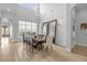 Elegant dining room with large windows and a statement chandelier at 494 Muirfield Loop, Reunion, FL 34747