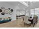 Open concept dining area with a large wooden table and views into the kitchen at 494 Muirfield Loop, Reunion, FL 34747