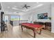 Game room features a pool table, TV, and seating at 494 Muirfield Loop, Reunion, FL 34747