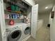 Convenient laundry room with washer, dryer, and shelving at 701 Virtuoso Ln # 81, Orlando, FL 32824