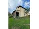 Tan house with a screened porch and landscaping at 701 Virtuoso Ln # 81, Orlando, FL 32824