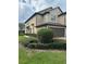Two-story townhome with landscaping and attached garage at 701 Virtuoso Ln # 81, Orlando, FL 32824