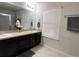 Double vanity bathroom with a large mirror and neutral color scheme at 701 Virtuoso Ln # 81, Orlando, FL 32824