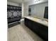 Bathroom with double vanity, shower/tub combo, and tile floors at 701 Virtuoso Ln # 81, Orlando, FL 32824