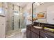 Spa-like bathroom with a glass shower and dark vanity at 1125 Grand Traverse Pkwy, Reunion, FL 34747