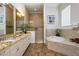 Large bathroom with double vanities, soaking tub, and walk-in shower at 1125 Grand Traverse Pkwy, Reunion, FL 34747