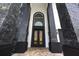 Modern house entrance with black metal double doors and stone accents at 1125 Grand Traverse Pkwy, Reunion, FL 34747