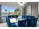 Formal dining room with a large glass table and blue chairs at 1125 Grand Traverse Pkwy, Reunion, FL 34747