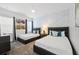 Spacious bedroom with two twin beds and stylish decor at 1125 Grand Traverse Pkwy, Reunion, FL 34747