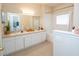 Bright bathroom with double sinks, tub, and shower at 3593 Conroy Rd # 437, Orlando, FL 32839