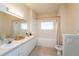 Bright bathroom with double sinks, tub, and shower at 3593 Conroy Rd # 437, Orlando, FL 32839