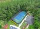 Tennis court with surrounding trees and a small building at 3593 Conroy Rd # 437, Orlando, FL 32839