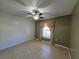 Bright bedroom with tile flooring, window, and ceiling fan at 7139 Cedarcrest Blvd, Lakeland, FL 33810