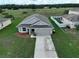 Single-story home with a two-car garage and driveway at 2513 Rock Pl, Kissimmee, FL 34759