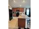 Island kitchen with wood cabinets and granite counters at 2513 Rock Pl, Kissimmee, FL 34759