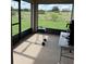 Covered patio with grill and outdoor seating, overlooking a grassy field at 2513 Rock Pl, Kissimmee, FL 34759