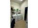 Laundry room with washer, dryer, and shelving for storage at 2513 Rock Pl, Kissimmee, FL 34759