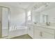 Elegant bathroom with double vanity and garden tub at 176 Flag Lilly Ln, Umatilla, FL 32784