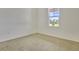 Spacious bedroom with neutral carpeting and large window at 176 Flag Lilly Ln, Umatilla, FL 32784