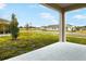 Covered patio overlooking a well-maintained lawn and neighborhood at 176 Flag Lilly Ln, Umatilla, FL 32784