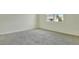 Well-lit bedroom featuring neutral wall paint and carpet at 176 Flag Lilly Ln, Umatilla, FL 32784